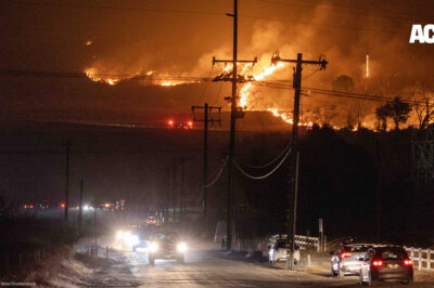 Hughes fire, in Castaic, burns on a hill threatening the freeway below while cars attempt to escape.