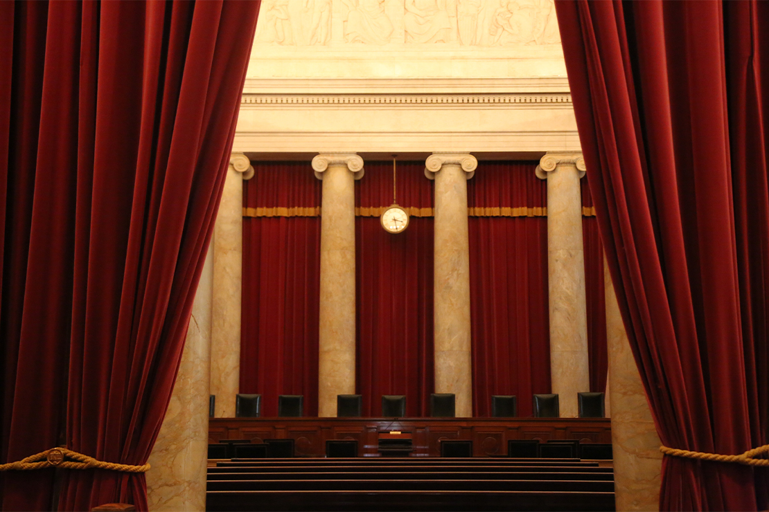 A. dark, interior shot of the empty judges chambers at Supreme Court of the United States building.