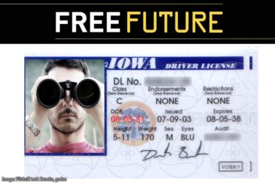 A driver's license in which the photo shows a man peering at the camera through binoculars
