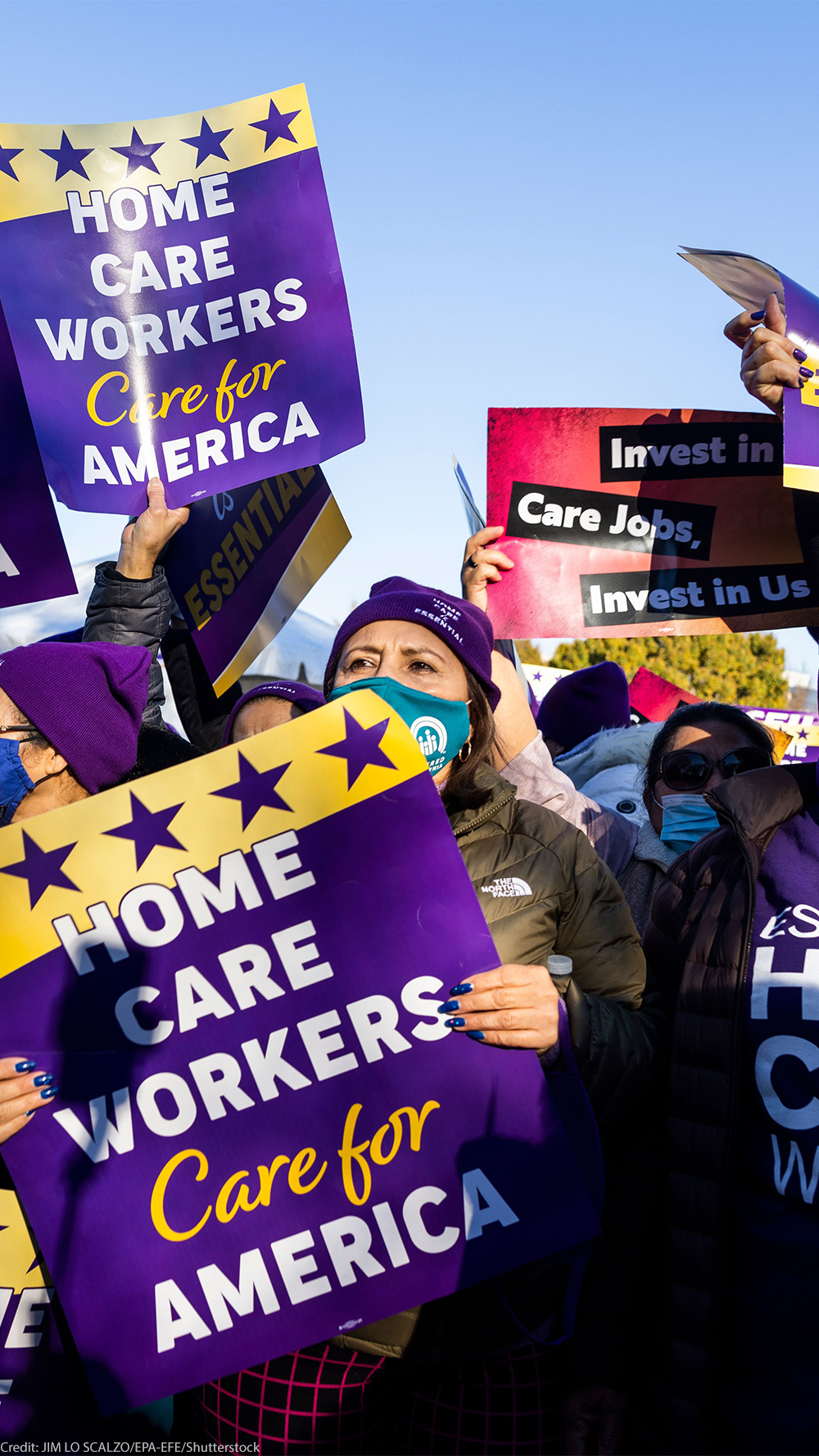 Multiple demonstrators hold up signs that read" "HOME CARE WORKERS CARE FOR AMERICA".