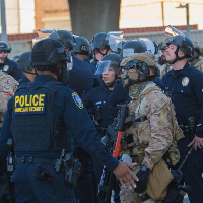 Border Patrol agents and police congregating during during a demonstration against expanded ICE operations and in support of immigrant rights.