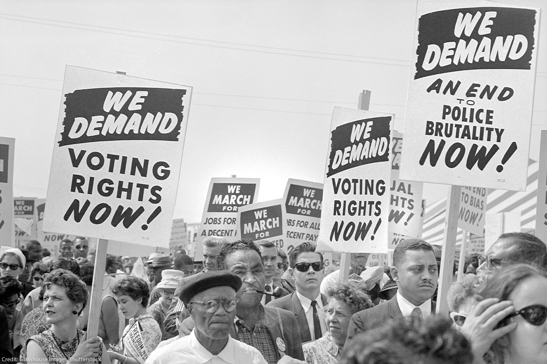 Protesters with signs at march on Washington, D.C. for Jobs and Freedom, carrying signs that read "WE DEMAND VOTING RIGHTS NOW!" and WE DEMAND AN END O POLICE BRUTALITY NOW!" on August 28, 1963.